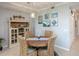 Dining room features a round wooden table, wicker chairs, and coastal-themed decor at 7005 River Hammock Dr # 303, Bradenton, FL 34212