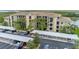 Exterior of condo building showcasing ample parking, covered spaces, and a tranquil lake view at 7005 River Hammock Dr # 303, Bradenton, FL 34212