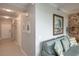 Hallway with views of living room and bathroom, including decorative wall art and modern lighting at 7005 River Hammock Dr # 303, Bradenton, FL 34212