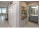 Interior hallway with bathroom, closet, and kitchen views, showcasing a bright and airy living space at 7005 River Hammock Dr # 303, Bradenton, FL 34212