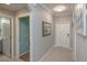 Hallway shot with doors to the bathroom, closet, and main entry; painted in neutral, calm tones at 7005 River Hammock Dr # 303, Bradenton, FL 34212