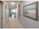 Hallway leading into a condo, complete with tile flooring, an archway, and decorative artwork at 7005 River Hammock Dr # 303, Bradenton, FL 34212
