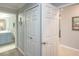 Hallway, with views of the bathroom, closet, and a painting on the wall at 7005 River Hammock Dr # 303, Bradenton, FL 34212