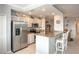 Bright kitchen with stainless steel appliances, granite countertops, and breakfast bar seating at 7005 River Hammock Dr # 303, Bradenton, FL 34212