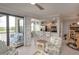 Living room with outside balcony access next to kitchen, dining room and comfortable armchair at 7005 River Hammock Dr # 303, Bradenton, FL 34212