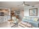 Open-concept living room with dining area, comfortable seating, and beachy decorations at 7005 River Hammock Dr # 303, Bradenton, FL 34212