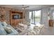Cozy living room with wood paneling, comfortable seating, and a sliding glass door to a balcony at 7005 River Hammock Dr # 303, Bradenton, FL 34212