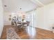 Open-concept living space with hardwood floors, dining table, and modern lighting at 717 84Th Nw St, Bradenton, FL 34209