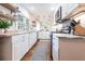 Modern kitchen featuring white cabinets, marble countertops, stainless steel appliances, and hardwood floors at 717 84Th Nw St, Bradenton, FL 34209
