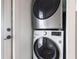 Modern stainless steel, front-loading, stacked washer and dryer units at 717 84Th Nw St, Bradenton, FL 34209