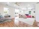 Open living room featuring hardwood floors, large windows providing natural light, and an adjacent built-in desk area at 717 84Th Nw St, Bradenton, FL 34209