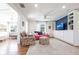 Open living room with hardwood floors, featuring a cozy seating area and built-in shelving and storage at 717 84Th Nw St, Bradenton, FL 34209