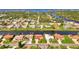 Aerial view of a waterfront community, highlighting the home's location on the water with lush surroundings at 74 Windsor Dr, Englewood, FL 34223