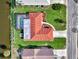 Waterfront home featuring a screened-in pool and well-maintained landscaping at 74 Windsor Dr, Englewood, FL 34223