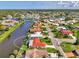 Aerial view of community homes with a large waterway offering a private oasis at 74 Windsor Dr, Englewood, FL 34223