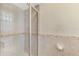 The bathroom shower features glass doors, white tiles, and decorative border at 74 Windsor Dr, Englewood, FL 34223