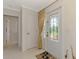 Bright entryway featuring a decorative glass front door, neutral walls, and tile flooring, creating a welcoming ambiance at 74 Windsor Dr, Englewood, FL 34223