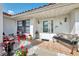 Inviting front porch featuring a cozy seating area, decorative tiles, and a stylish front door with glass accents at 74 Windsor Dr, Englewood, FL 34223