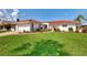 Beautiful house with a red tile roof, pristine lawn, and well-maintained landscaping creating a welcoming entrance at 74 Windsor Dr, Englewood, FL 34223