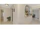 Inviting hallway with arched opening into dining area and glimpse of the spacious kitchen, creating an open, flowing feel at 74 Windsor Dr, Englewood, FL 34223