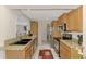 Well-equipped kitchen featuring stainless steel appliances, granite countertops, and warm wood cabinetry at 74 Windsor Dr, Englewood, FL 34223