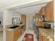 Well-equipped kitchen featuring stainless steel appliances, granite countertops, and warm wood cabinetry at 74 Windsor Dr, Englewood, FL 34223