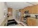 Modern kitchen with sleek stainless steel appliances, granite countertops, and ample cabinetry for storage at 74 Windsor Dr, Englewood, FL 34223