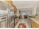 Open kitchen featuring stainless appliances, granite counters, and a breakfast nook with views at 74 Windsor Dr, Englewood, FL 34223