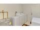 Functional laundry area with washer, dryer, water heater and extra storage space at 74 Windsor Dr, Englewood, FL 34223