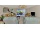 Comfortable living room with neutral tones, tile flooring, and sliding glass doors overlooking a patio and pool area at 74 Windsor Dr, Englewood, FL 34223