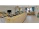 Open living room featuring tile flooring, comfortable seating, and large windows, creating a bright and inviting space at 74 Windsor Dr, Englewood, FL 34223