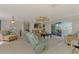 Spacious living room with tile flooring, a ceiling fan, and sliding glass doors leading to an outdoor space at 74 Windsor Dr, Englewood, FL 34223