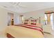 Spacious bedroom with comfortable furnishings, windows and access to the bathroom at 74 Windsor Dr, Englewood, FL 34223