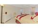 Cozy bedroom showcasing ceiling fan, and access to laundry and bathroom at 74 Windsor Dr, Englewood, FL 34223