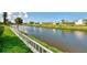 Wide canal is visible from the manicured lawn and shoreline, creating serene views at 74 Windsor Dr, Englewood, FL 34223