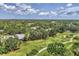 Picturesque aerial view showcasing the community, lush landscaping, golf course, and serene surroundings at 7617 Whitebridge Gln, University Park, FL 34201
