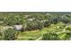 An aerial view of the golf course, manicured landscaping, surrounding trees and residential homes at 7617 Whitebridge Gln, University Park, FL 34201
