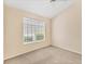 Neutral bedroom features a ceiling fan and large window for ample natural light at 7617 Whitebridge Gln, University Park, FL 34201