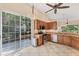Updated kitchen with stainless steel appliances, granite countertops, and sliding doors to patio at 7617 Whitebridge Gln, University Park, FL 34201