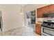 Bright kitchen with granite countertops and stainless steel appliances, plus a sliding door to patio at 7617 Whitebridge Gln, University Park, FL 34201