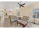 Bright, open living area featuring tile floors, comfortable seating, and seamless flow to the kitchen at 7617 Whitebridge Gln, University Park, FL 34201