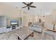 Open-concept living space with tile flooring, entertainment center, and views of kitchen at 7617 Whitebridge Gln, University Park, FL 34201