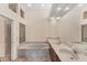 Spacious main bathroom features dual sinks, soaking tub, and walk-in shower at 7617 Whitebridge Gln, University Park, FL 34201