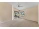 Bright main bedroom with neutral carpeting, ceiling fan, and screened porch access at 7617 Whitebridge Gln, University Park, FL 34201