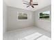 Empty bedroom features bright tile flooring and a ceiling fan with ample natural light at 8075 48Th N Ave, St Petersburg, FL 33709