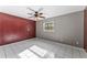 Bedroom showing accent wall, ceiling fan, tile flooring, and window at 8075 48Th N Ave, St Petersburg, FL 33709