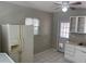 Bright kitchen with white appliances and refrigerator. View to back door at 8075 48Th N Ave, St Petersburg, FL 33709