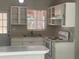Bright kitchen with white appliances, ample counter space, and a garden view at 8075 48Th N Ave, St Petersburg, FL 33709