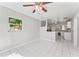 Bright living room with tiled floors, fan, and a view to the kitchen at 8075 48Th N Ave, St Petersburg, FL 33709