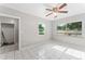 Bright living room has tile flooring, ceiling fan, and two large windows at 8075 48Th N Ave, St Petersburg, FL 33709